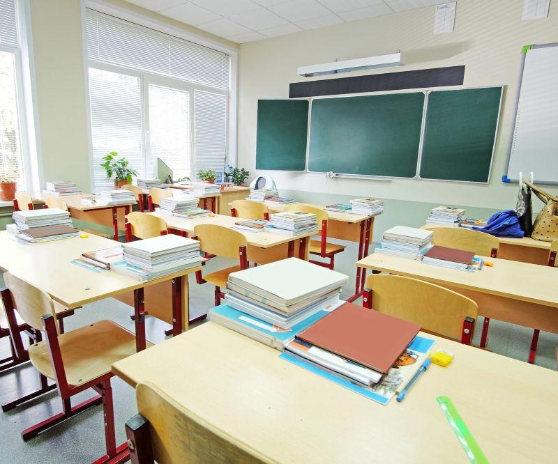 Classroom with desks, chairs and a chalkboard