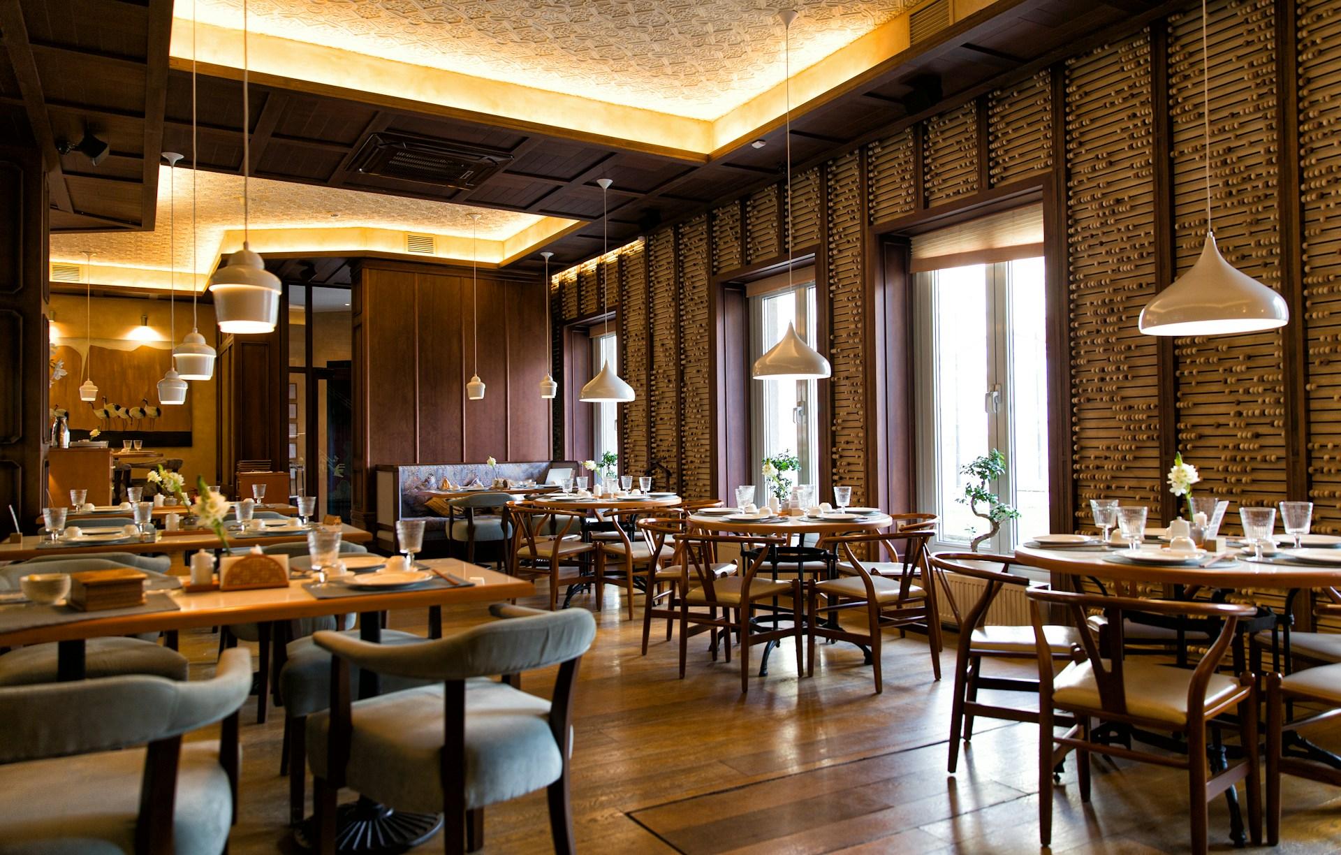 Warmly lit restaurant dining room with timber finishes